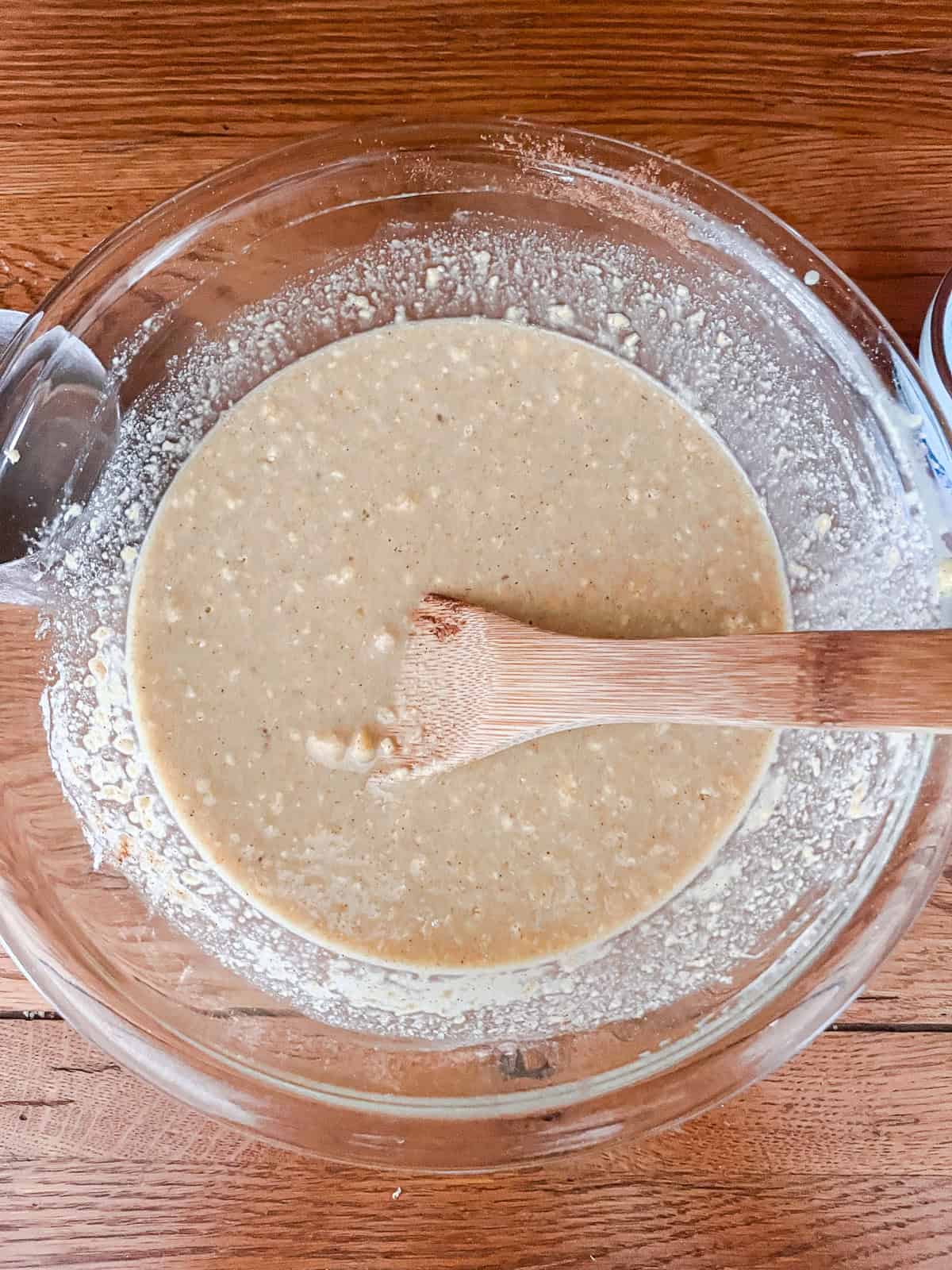 Fully mixed dutch baby pancake batter in a glass bowl.
