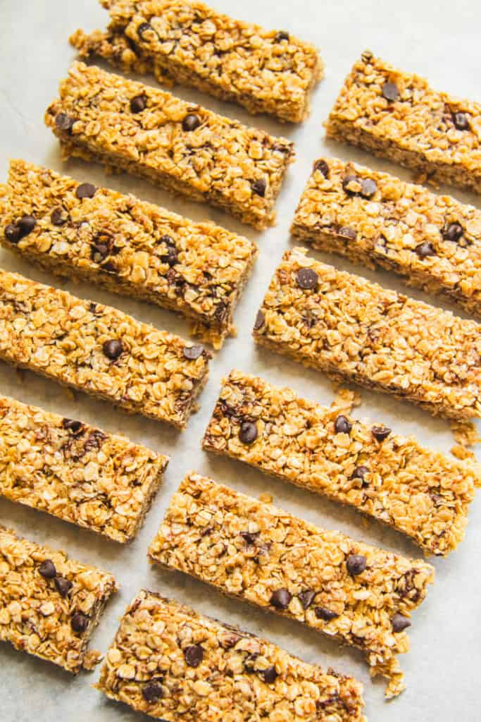 Homemade granola bars spread out on a table.