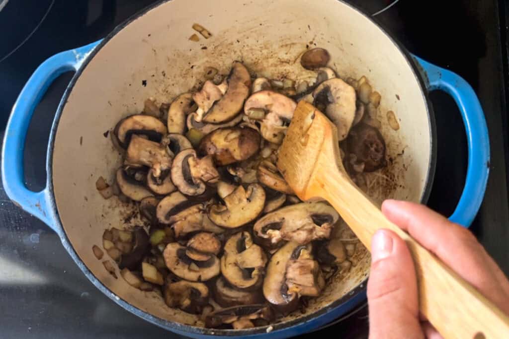 Sauteing mushrooms in a dutch oven.