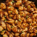 Honey garlic chicken in a cast iron skillet.