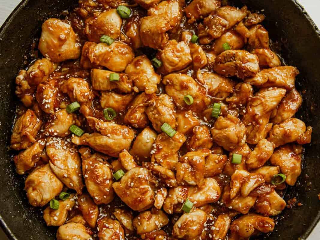 Honey garlic chicken in a cast iron skillet.