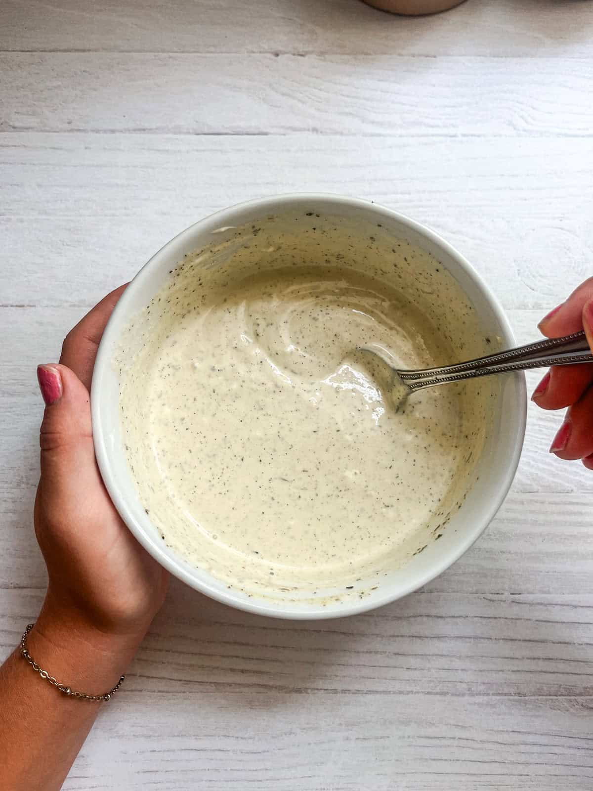 Stirring a bowl of ranch.