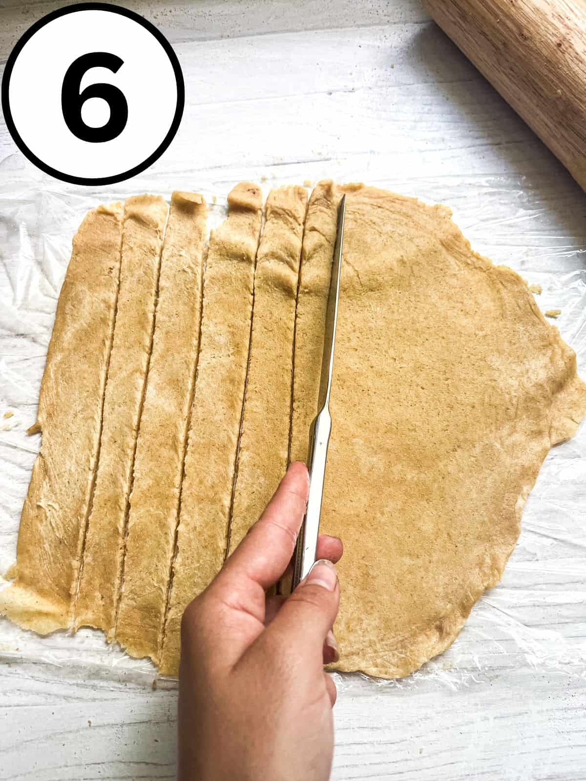 Cutting a pie crust into strips for a lattice.