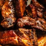 Country-style ribs in a dutch oven smothered in sauce.