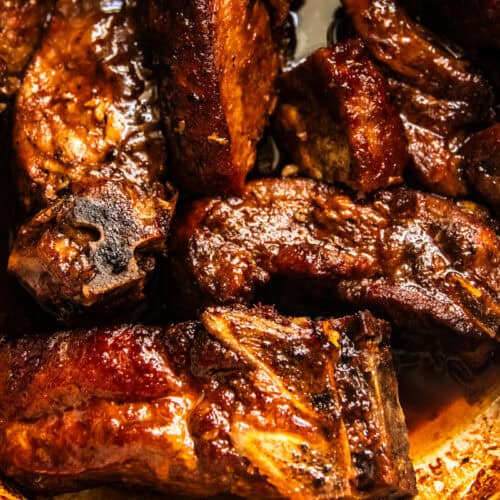 Country-style ribs in a dutch oven smothered in sauce.