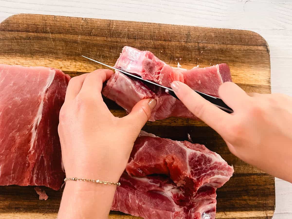 Cutting country-style ribs into thin pieces.