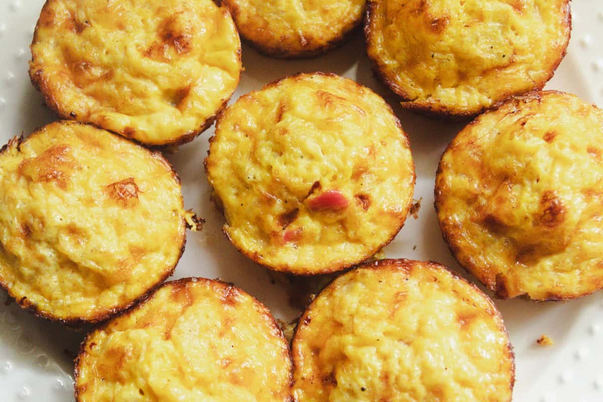 Egg muffins sitting on a white platter.