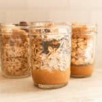 Three jars of overnight oats lined up on a counter.