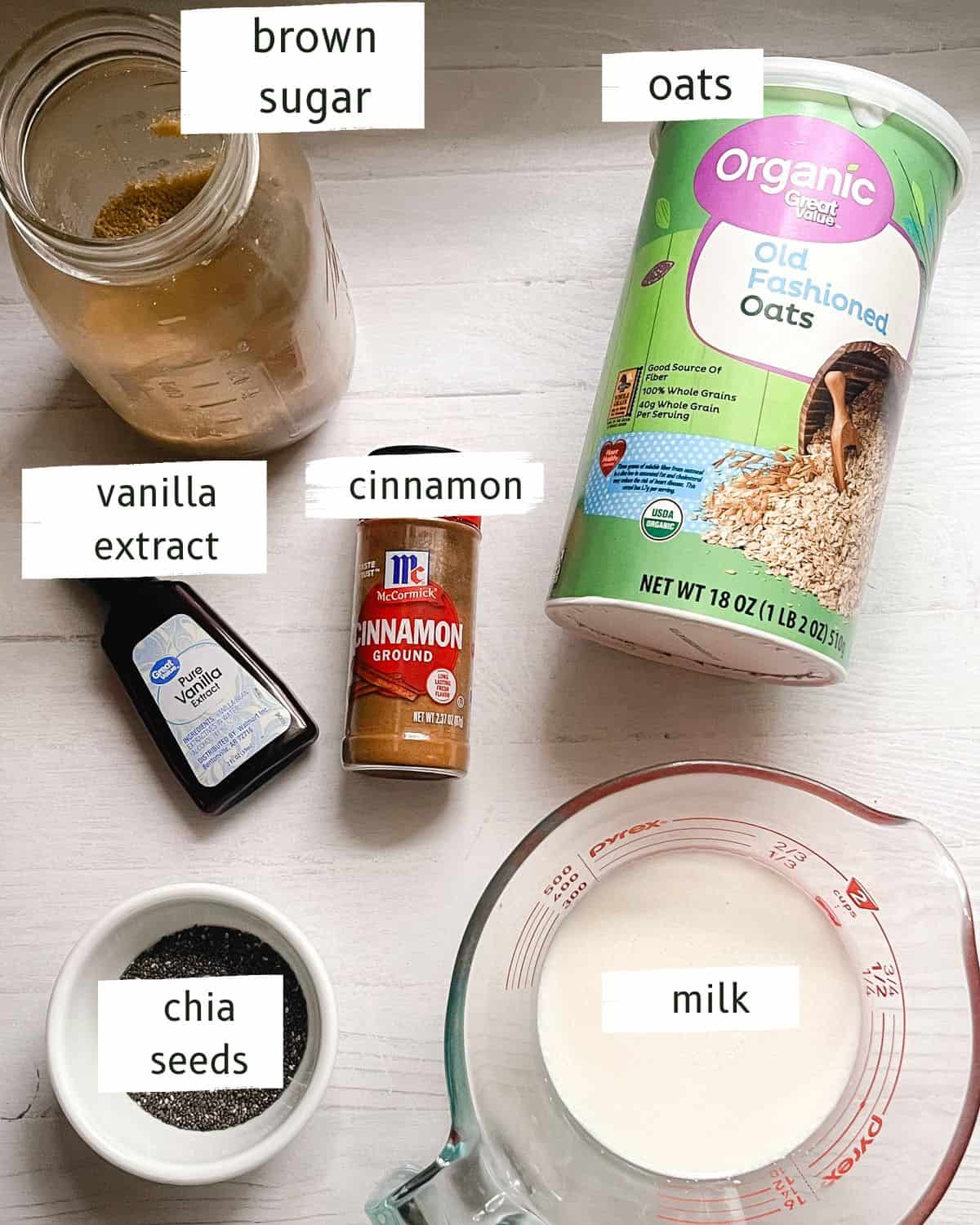 Overnight oats ingredients labeled on a white table.