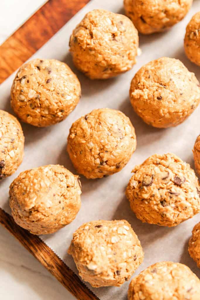 Protein balls on a parchment paper-lined baking sheet.