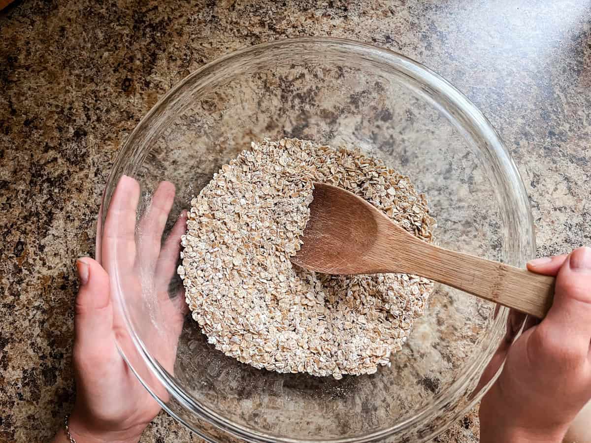 Stirring dry ingredients in a glass mixing bowl.