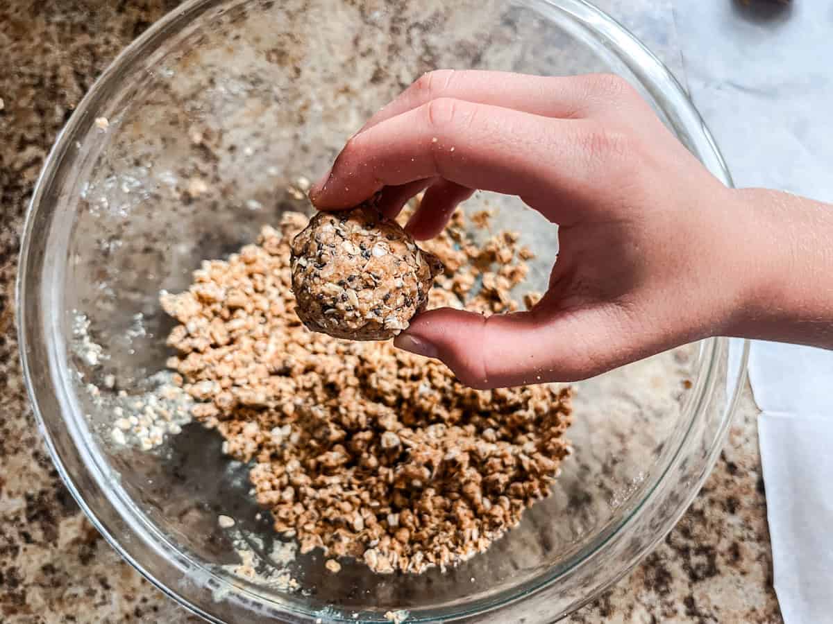 Shaping balls out of protein ball mixture, in a glass bowl. 