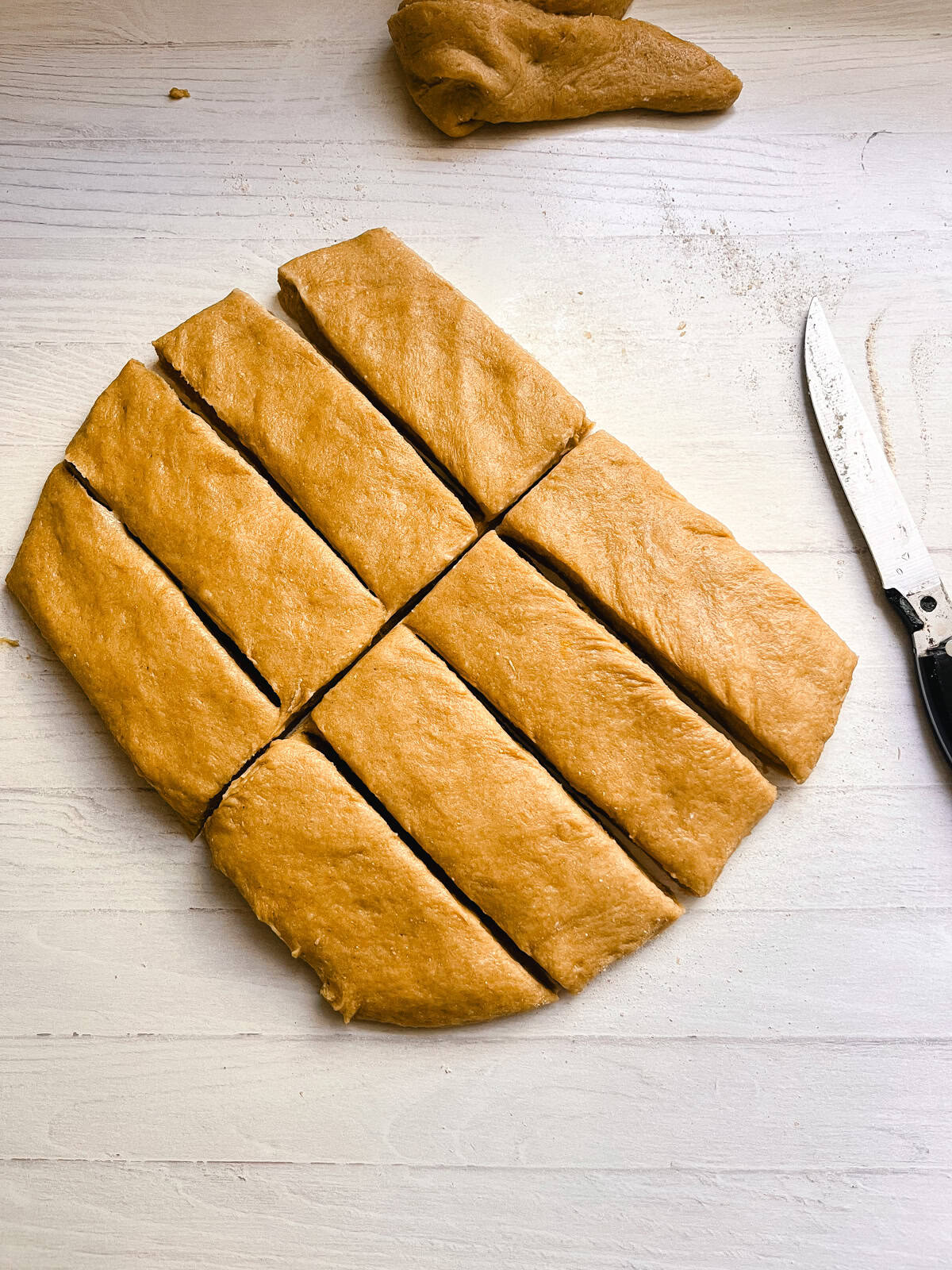 Donut dough, flattened and cut into rectangles.