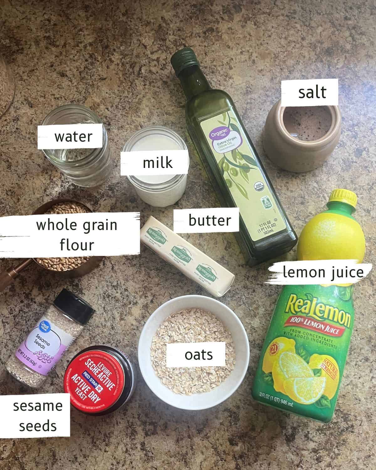 Whole grain seeded bread ingredients labeled on a kitchen counter.