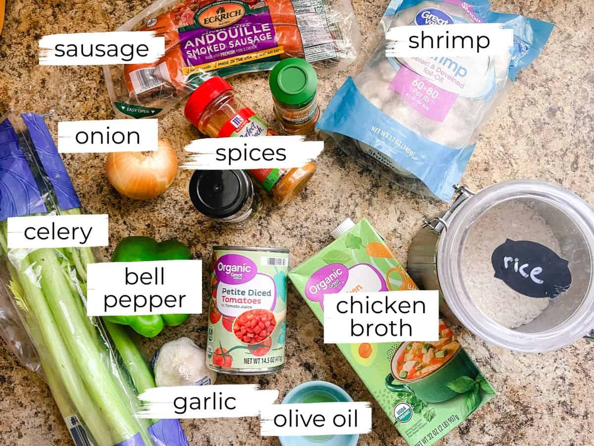 Dutch oven jambalaya ingredients labeled on a kitchen counter.