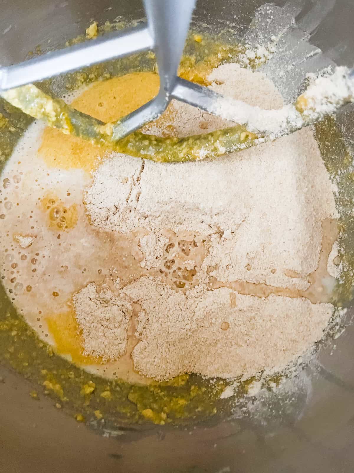 Whole grain cranberry bread ingredients in a stand mixer.