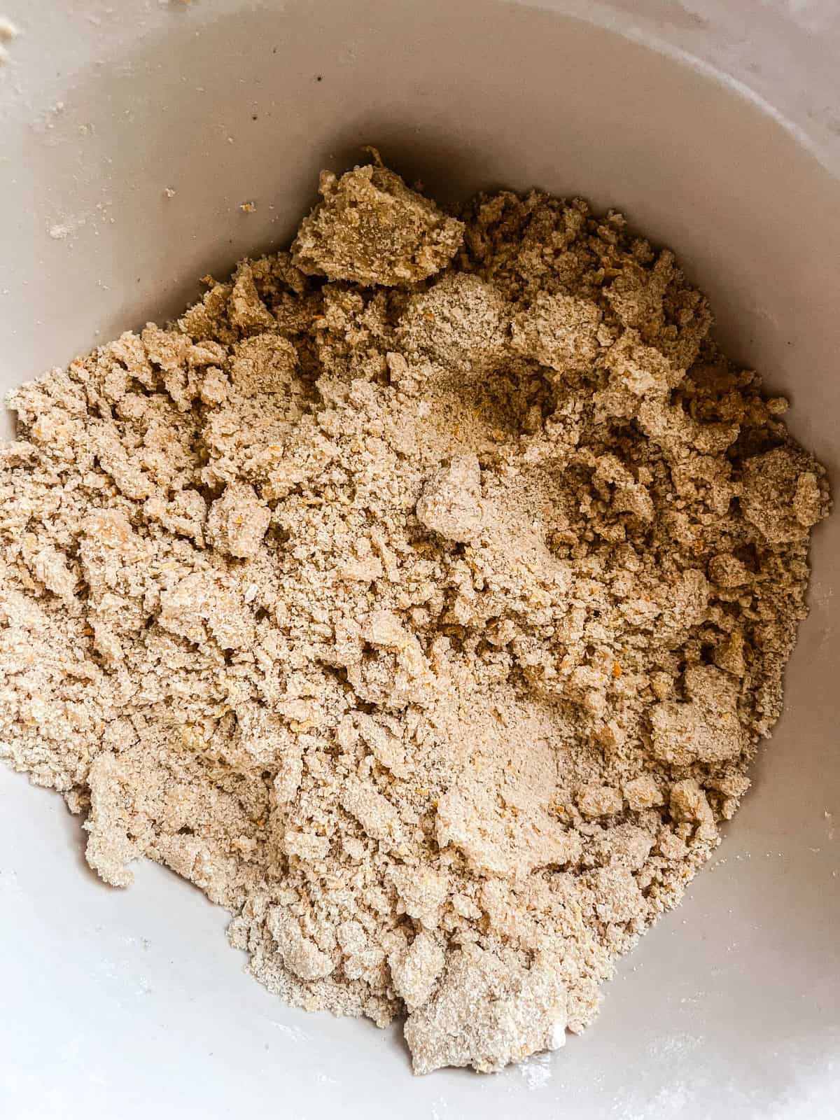 Crumbly mixture of frozen butter and dry ingredients in a bowl.