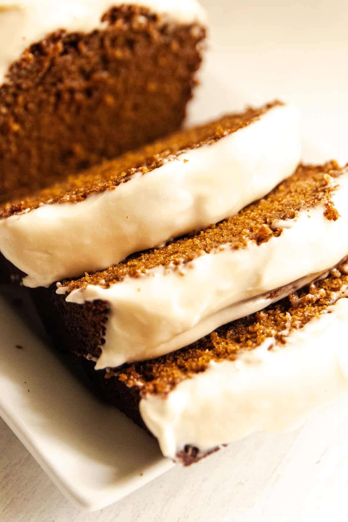 Thick slices of gingerbread that is made with freshly milled flour and topped with a cream cheese glaze.