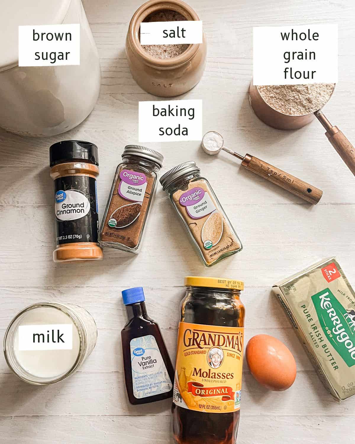 Whole grain ginger bread ingredients labeled on a white table.