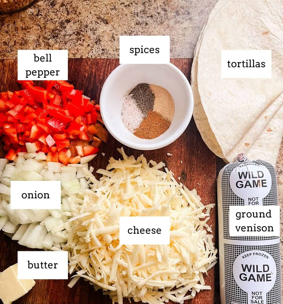 Venison quesadilla ingredients labeled on a wooden cutting board.