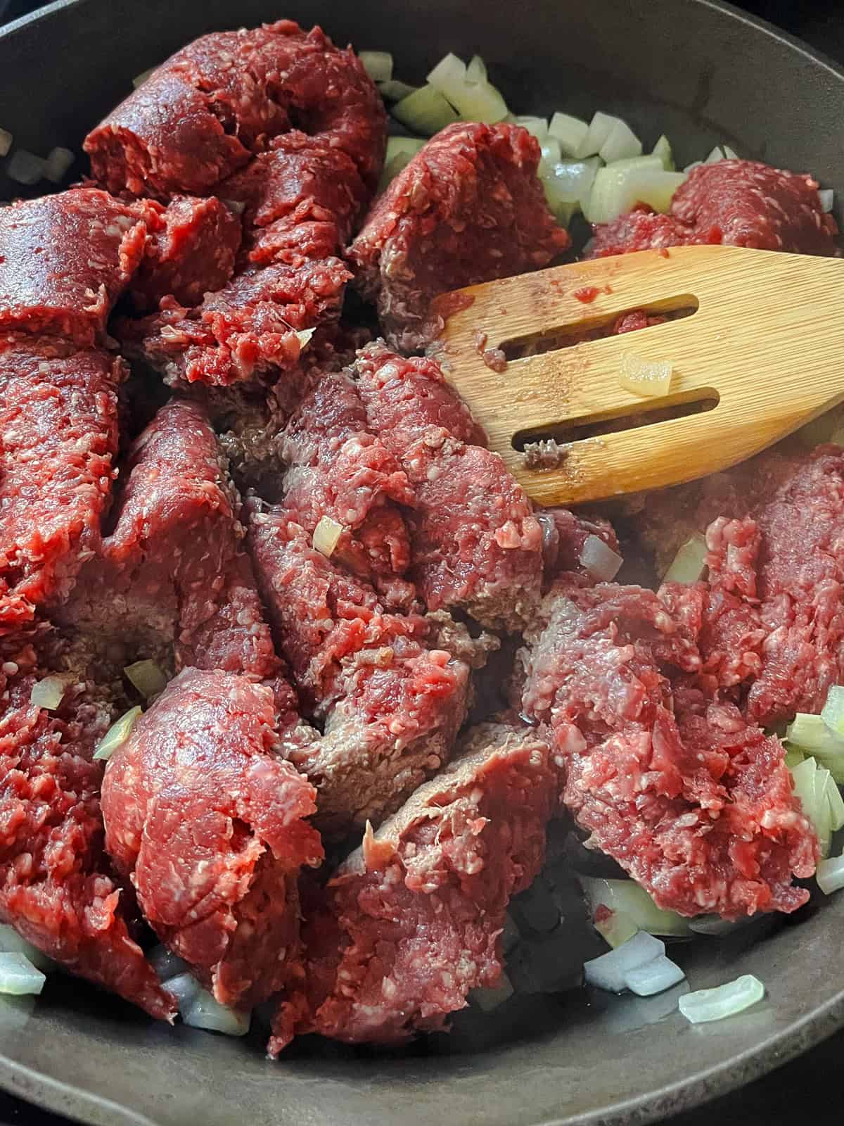 Browning venison in a cast iron skillet.