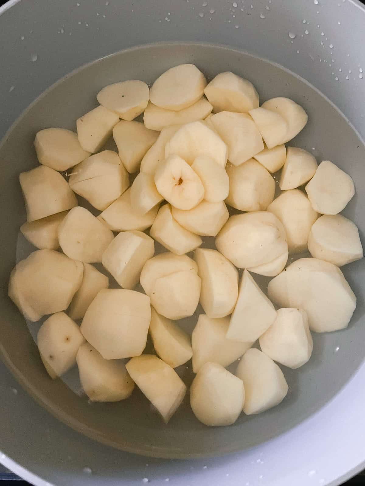 Potatoes in a pot of water.