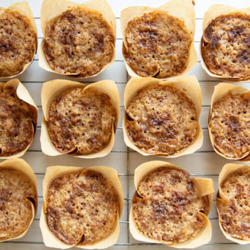 Freshly milled flour muffins cooling on a cooling rack.