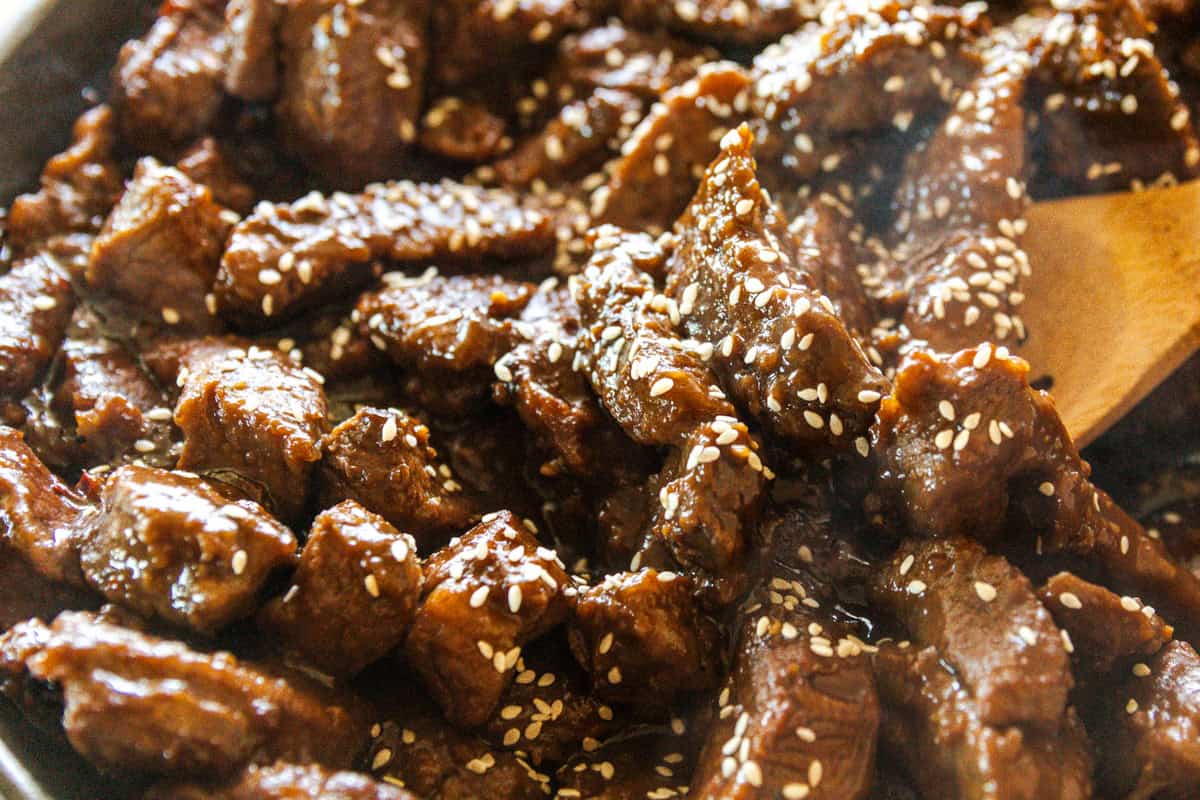 Stirring up venison steak that is tossed in a garlic ginger sauce.