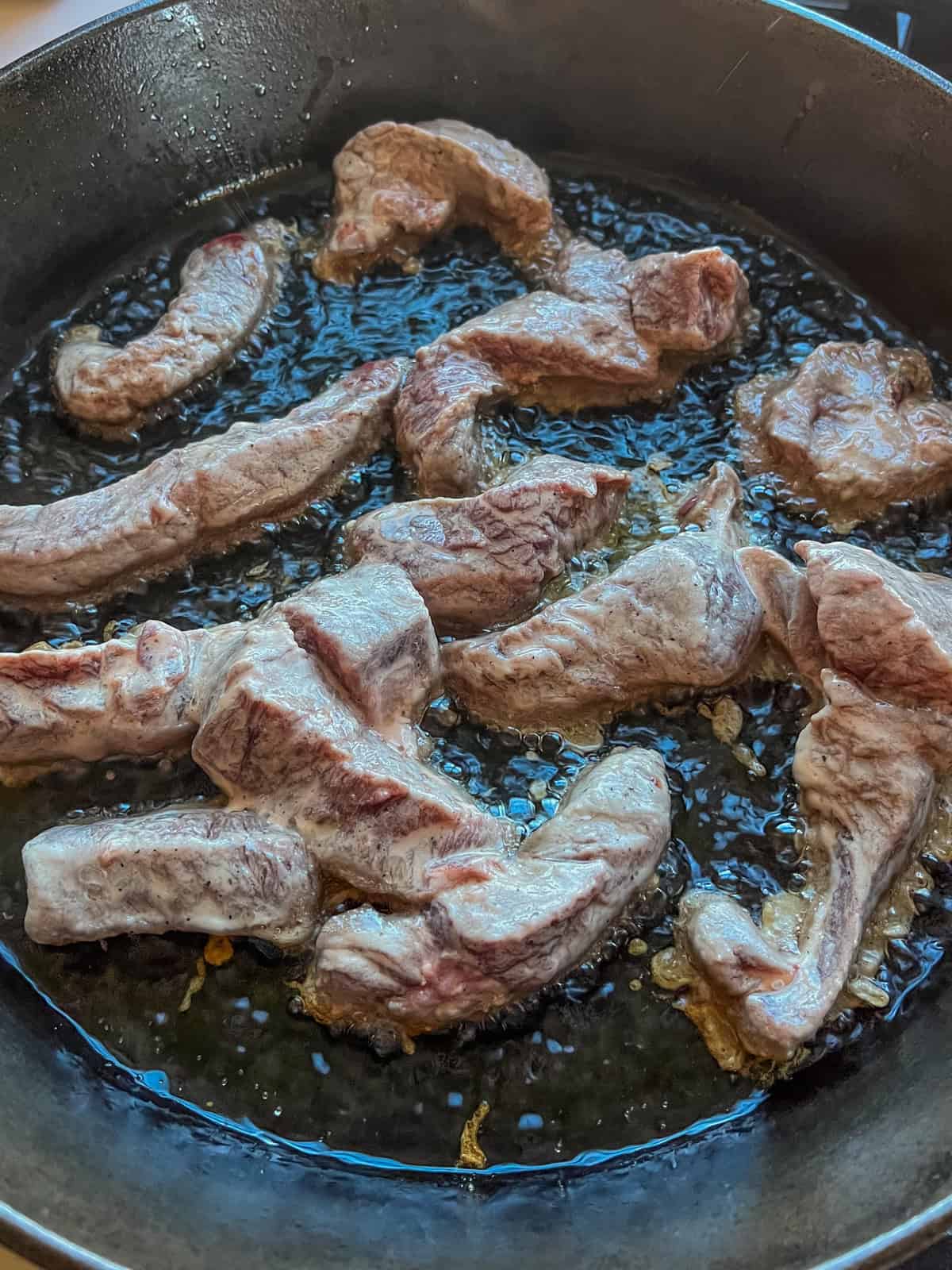 Cooking garlic ginger venison in a cast iron skillet.