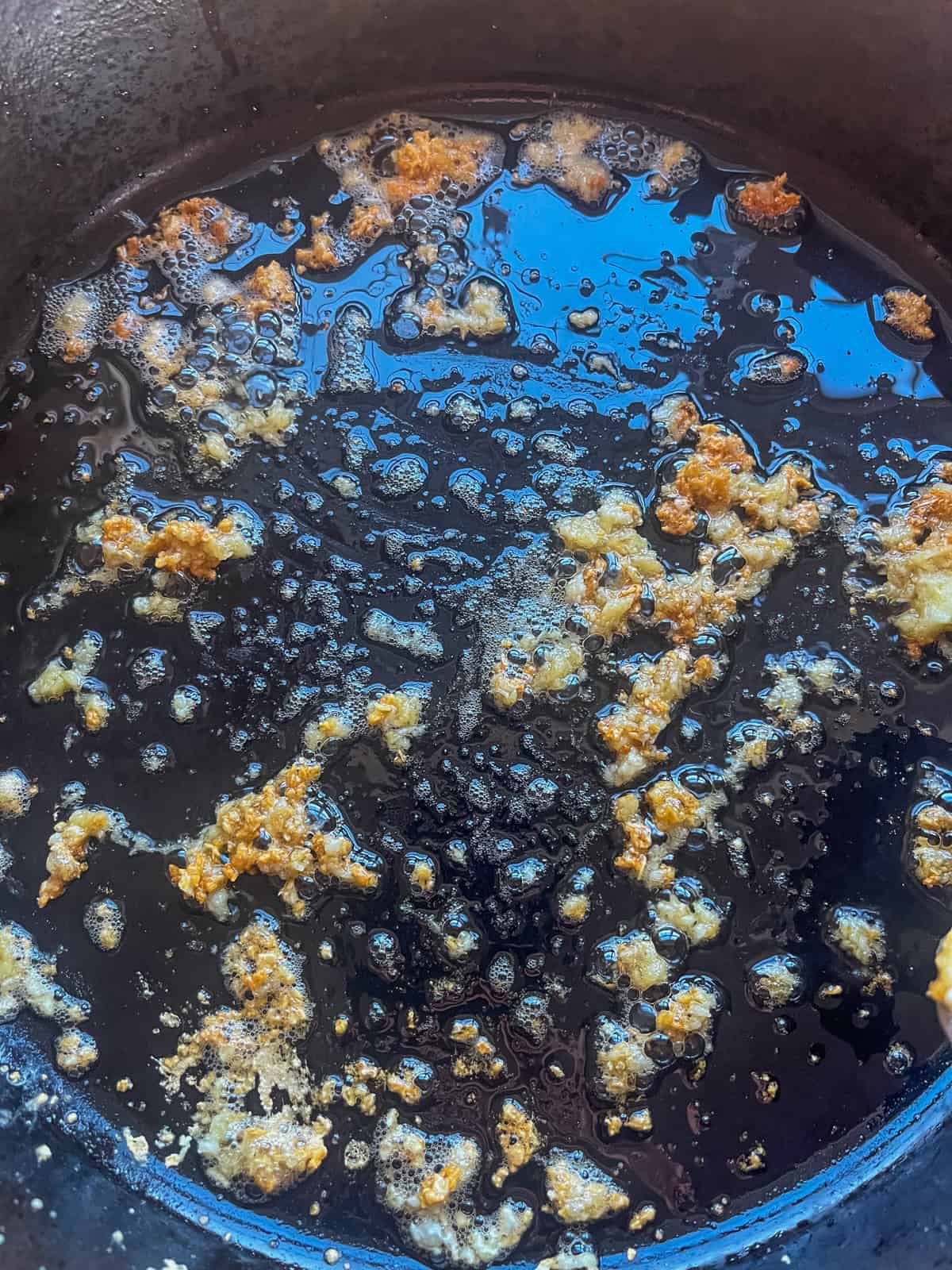 Cooking garlic and ginger in a cast iron skillet.