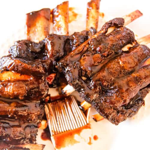 Tender fall off the bone venison ribs on a plate.