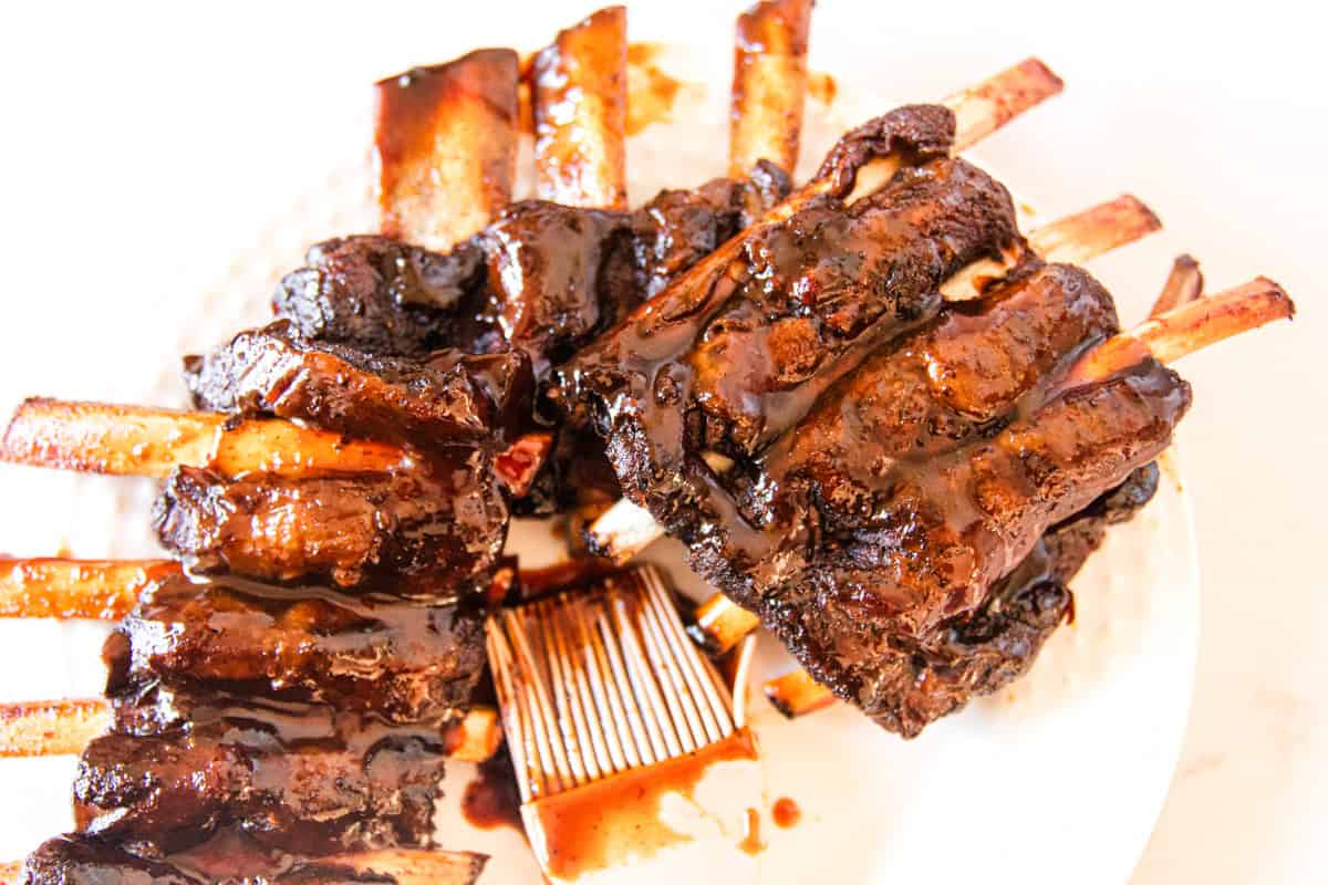 Tender fall off the bone venison ribs on a plate.