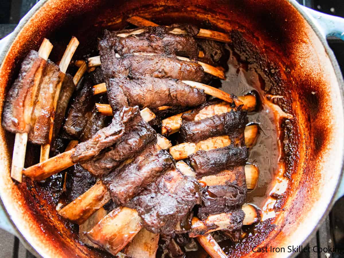 Braised venison ribs in a dutch oven. 