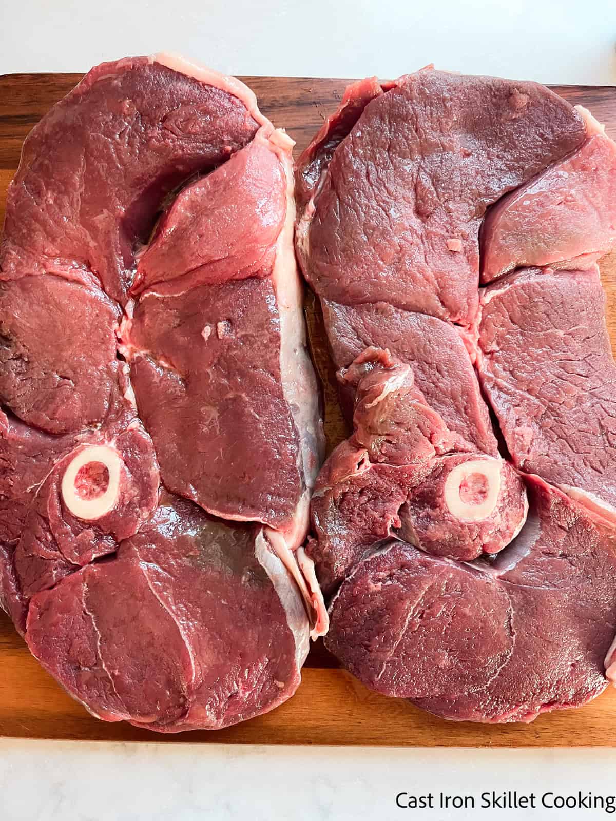 Venison sirloin uncooked on a wooden board.