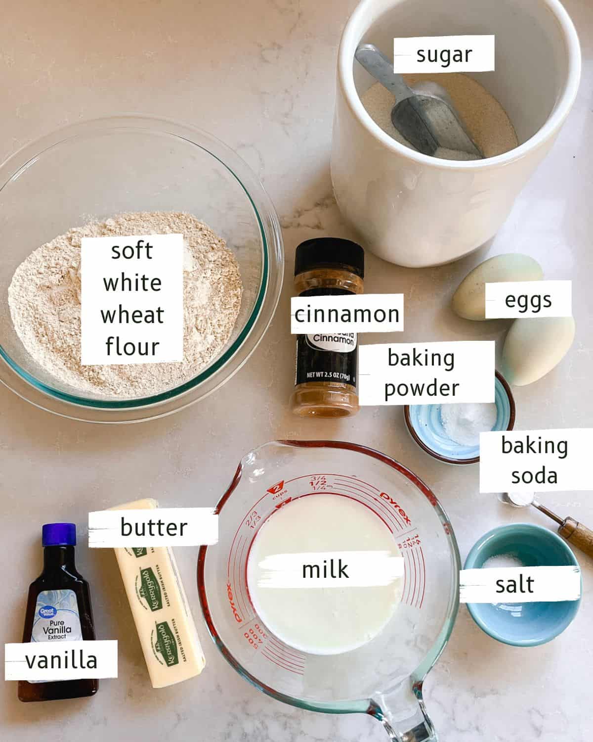 Fresh milled cinnamon swirl bread ingredients labeled on a white kitchen counter.