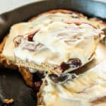 Serving fresh milled strawberry sweet rolls out of a cast iron skillet.