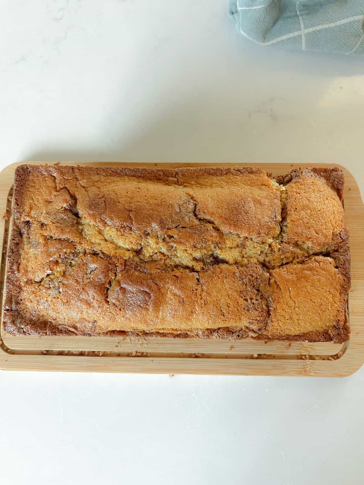 A loaf of fresh milled flour on a wooden cutting board.