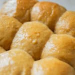 Fresh milled flour Hawaiian rolls cooling on a baking rack.