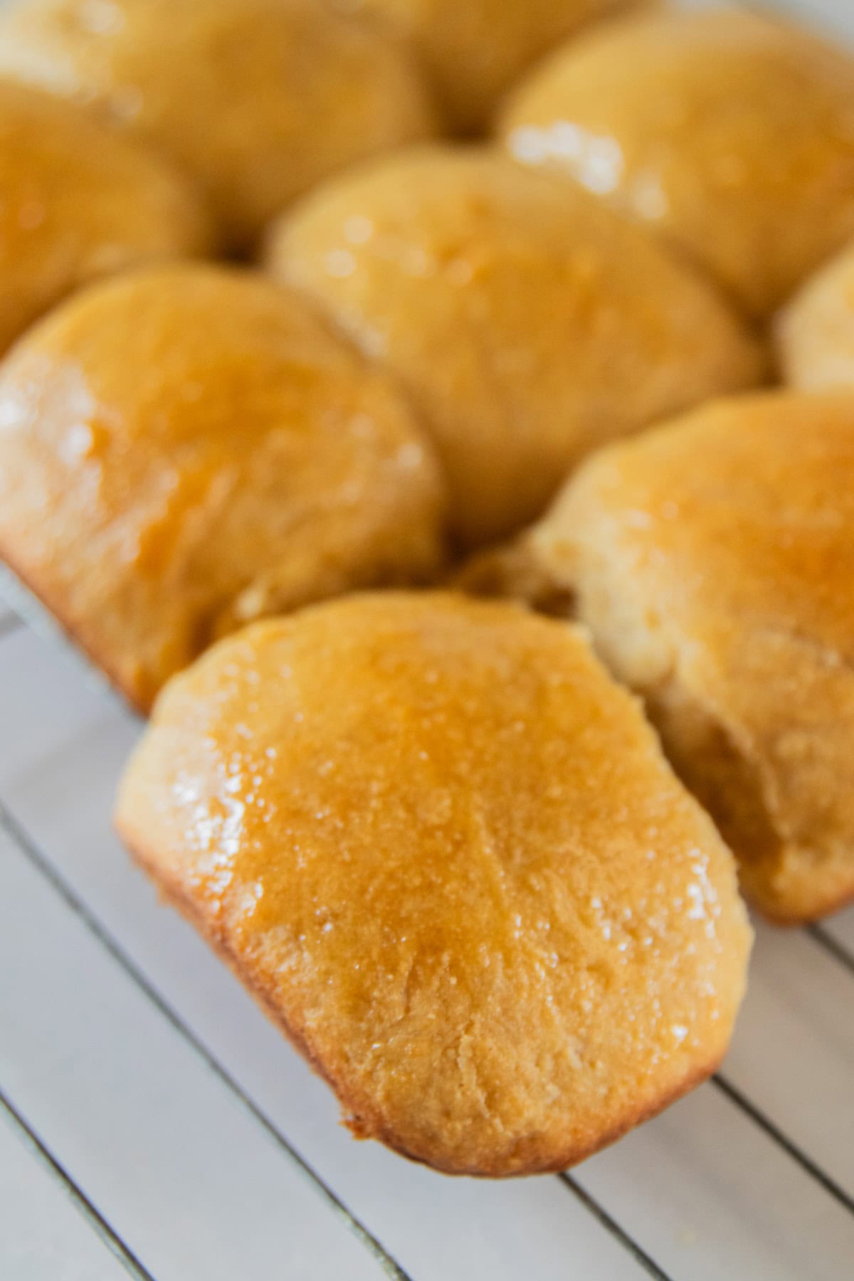 Fresh milled flour Hawaiian rolls on a cooling rack. 