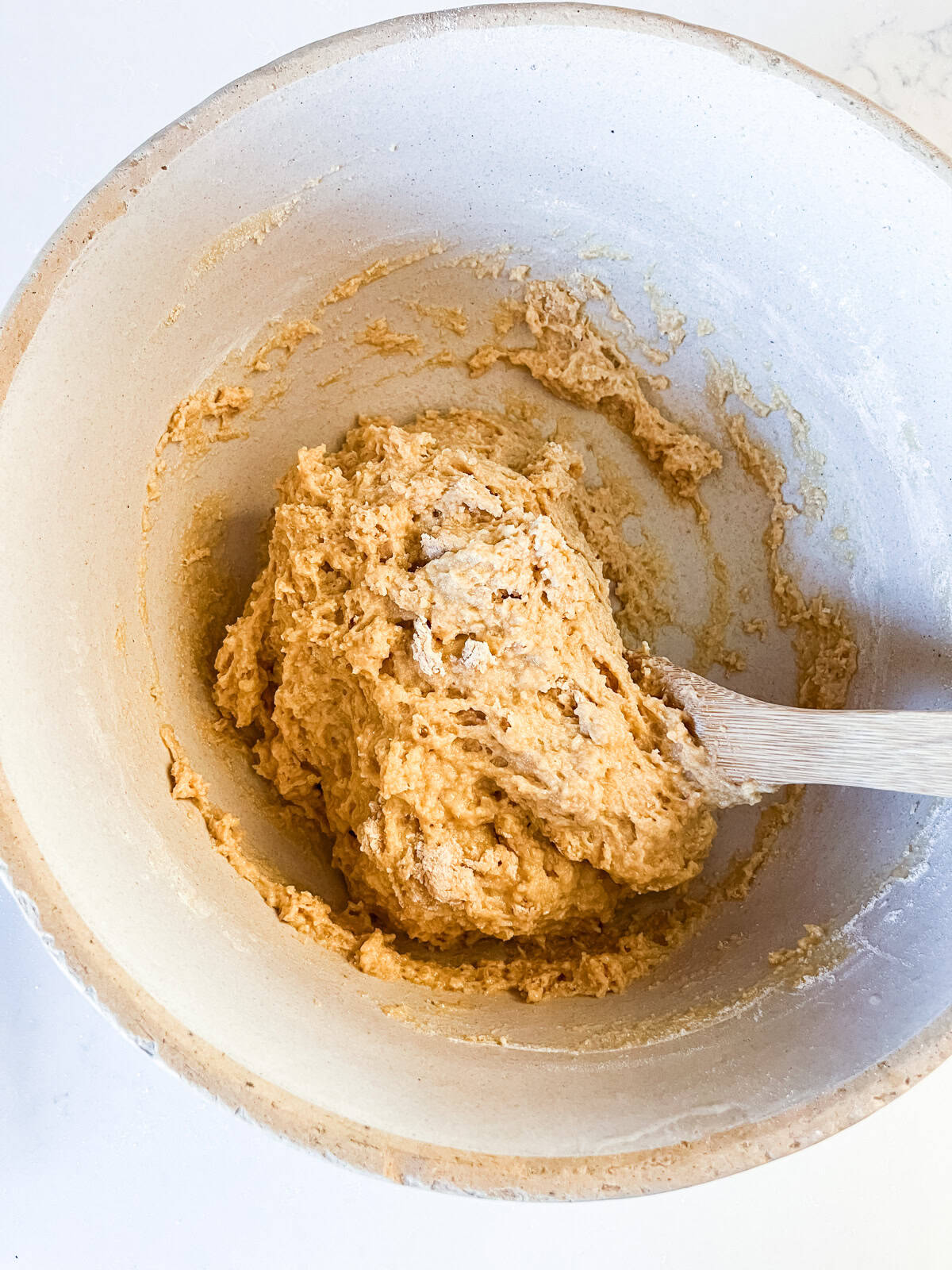 Stirring fresh milled flour Hawaiian roll dough in a mixing bowl.