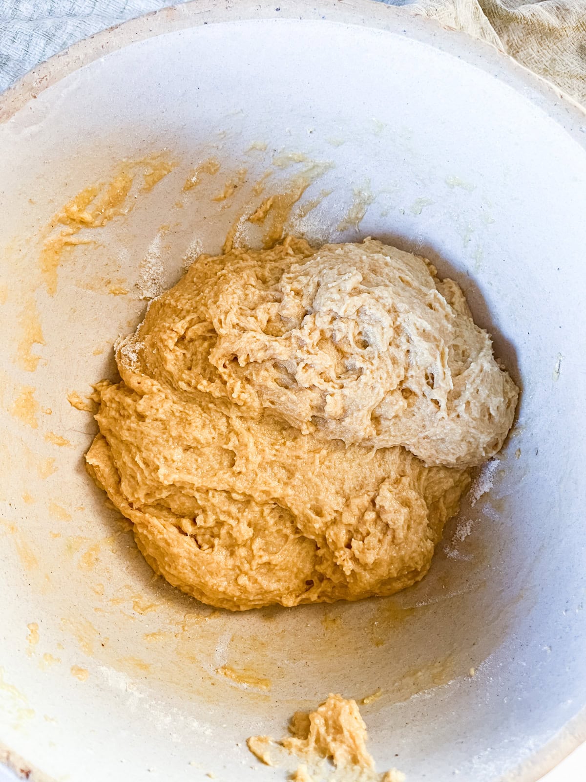 Hawaiian rolls dough ball sitting in a mixing bowl.