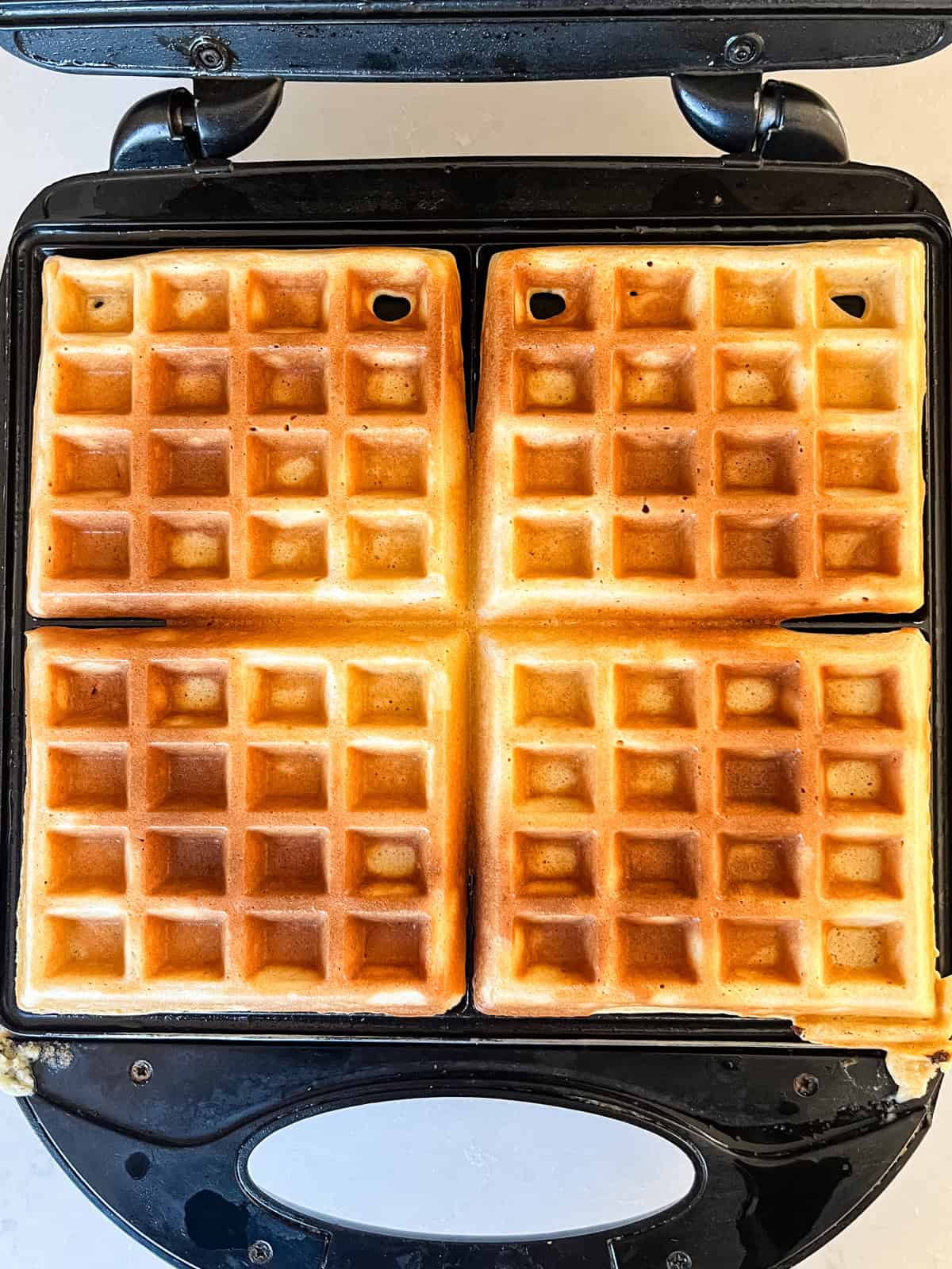 Cooking fresh milled waffles on a cast iron waffle maker.