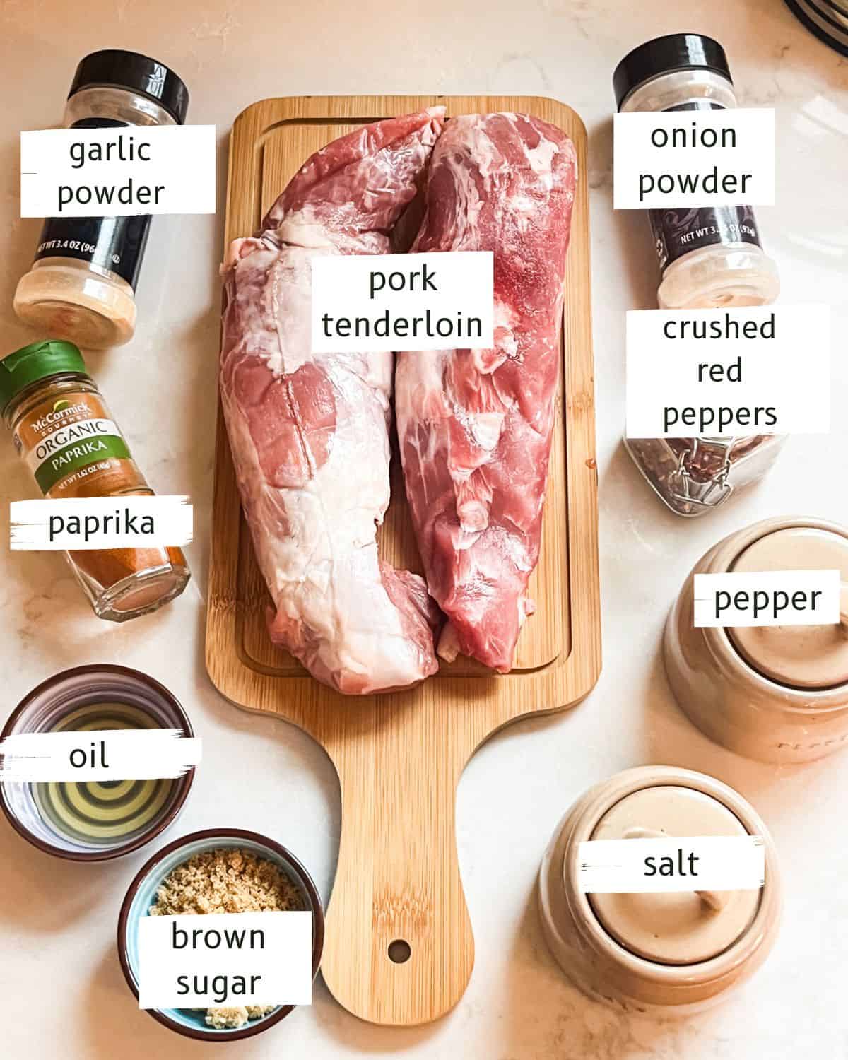 Baked pork tenderloin ingredients labeled on a white countertop.