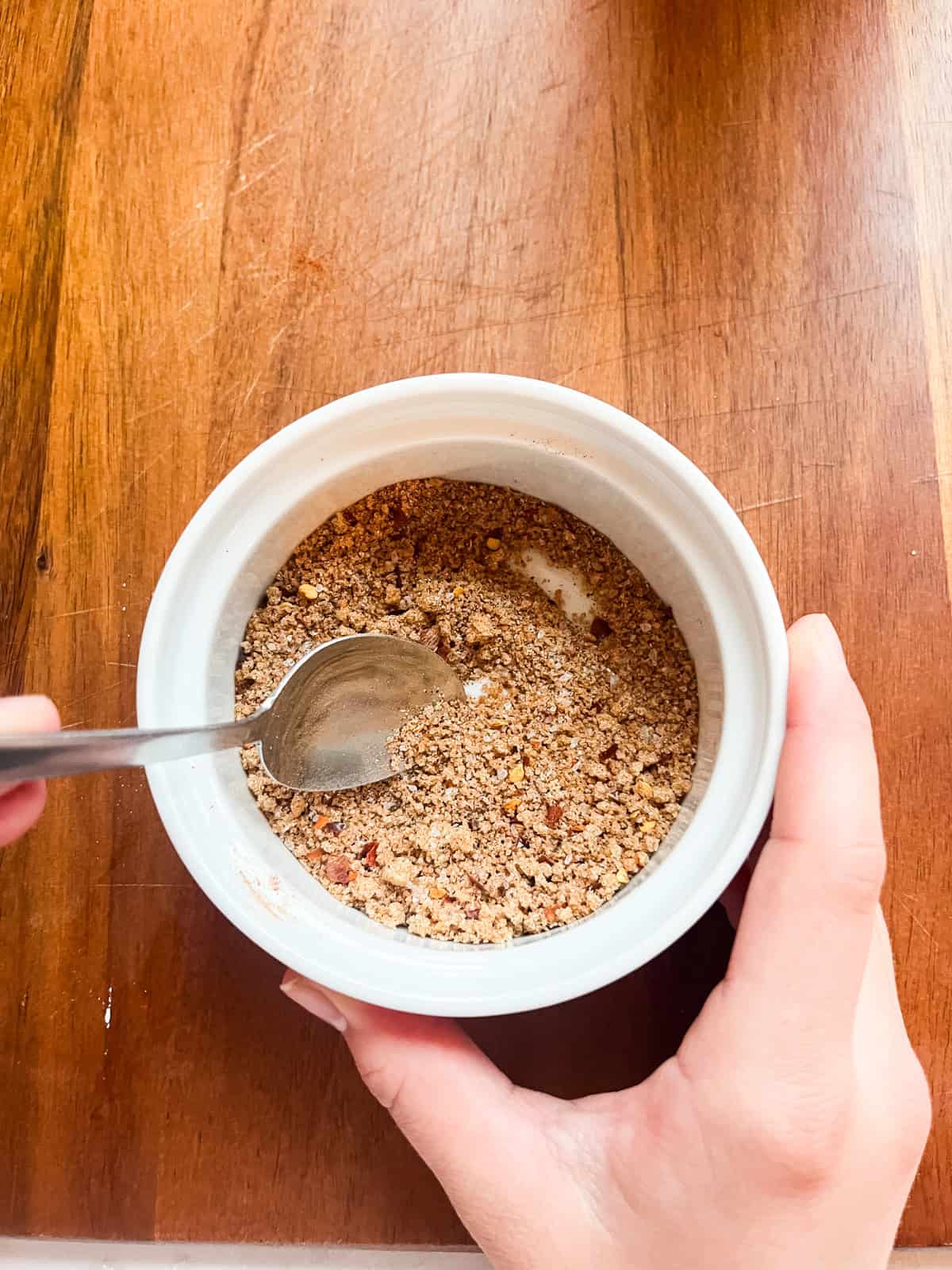Mixing together a bowl of homemade meat rub.