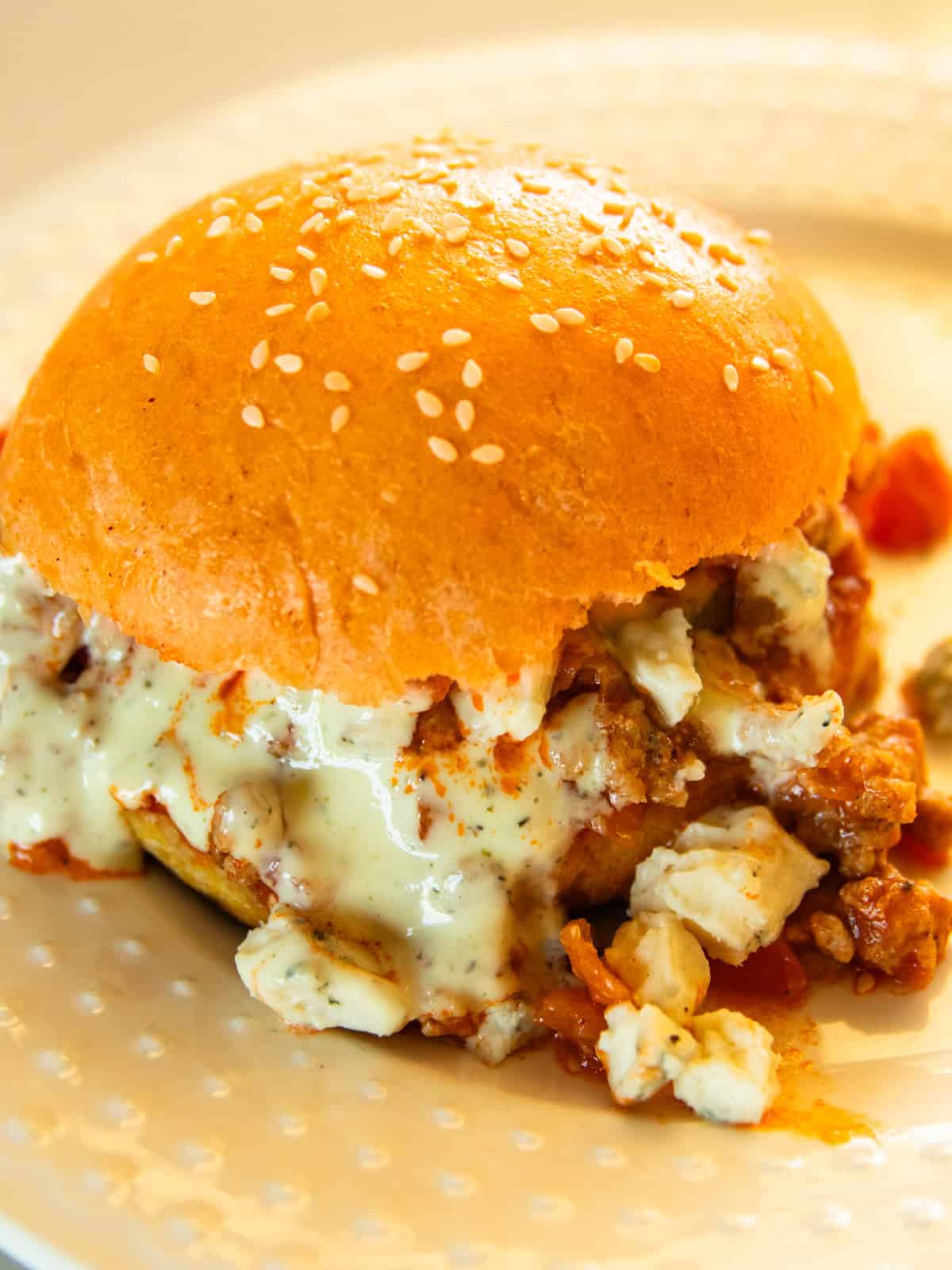 A buffalo chicken sloppy joes on a white plate. 