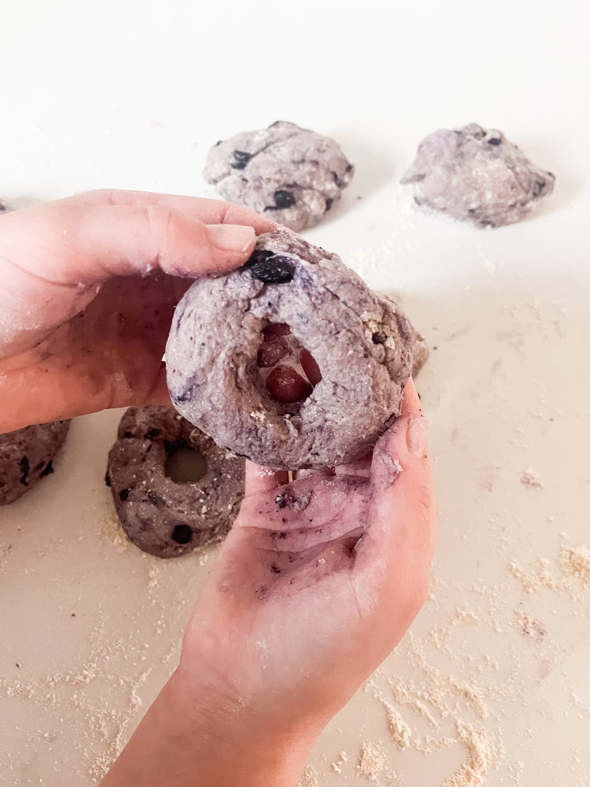 Shaping fresh milled blueberry bagels.