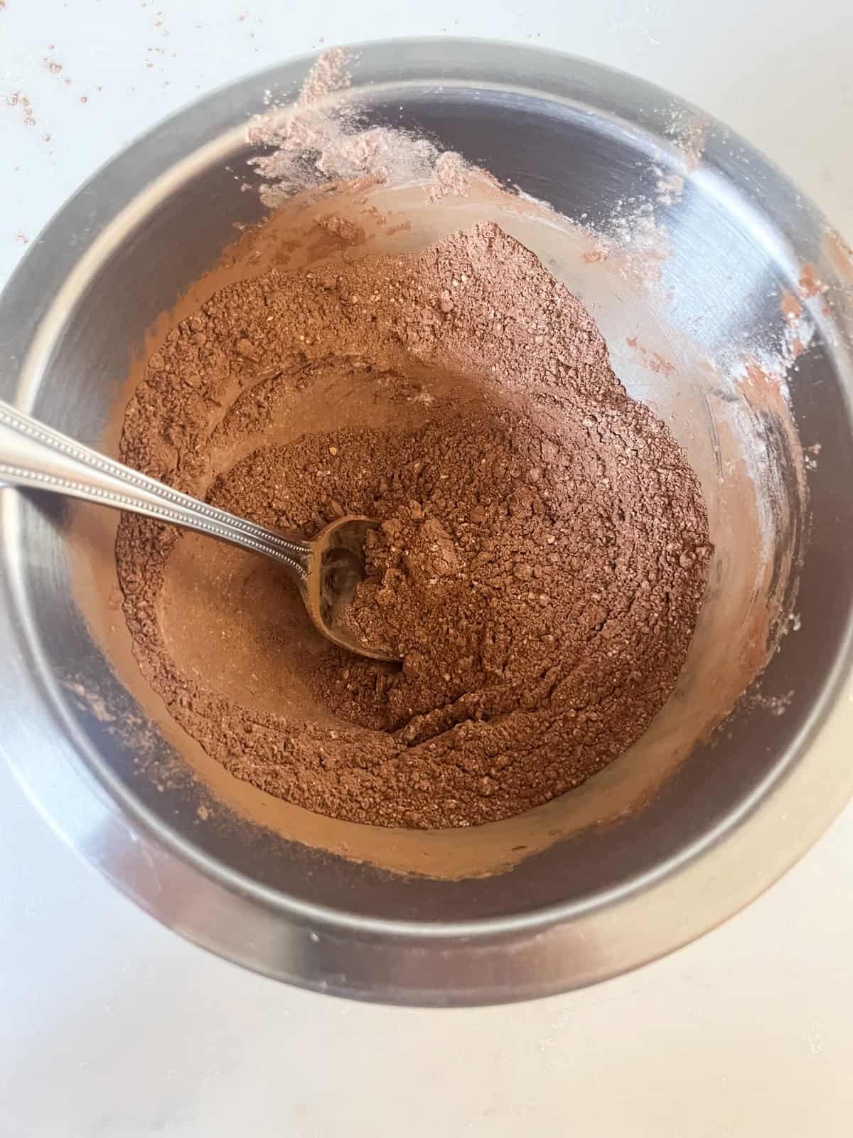 Mixing dry ingredients for fresh milled brownies in a metal mixing bowl.