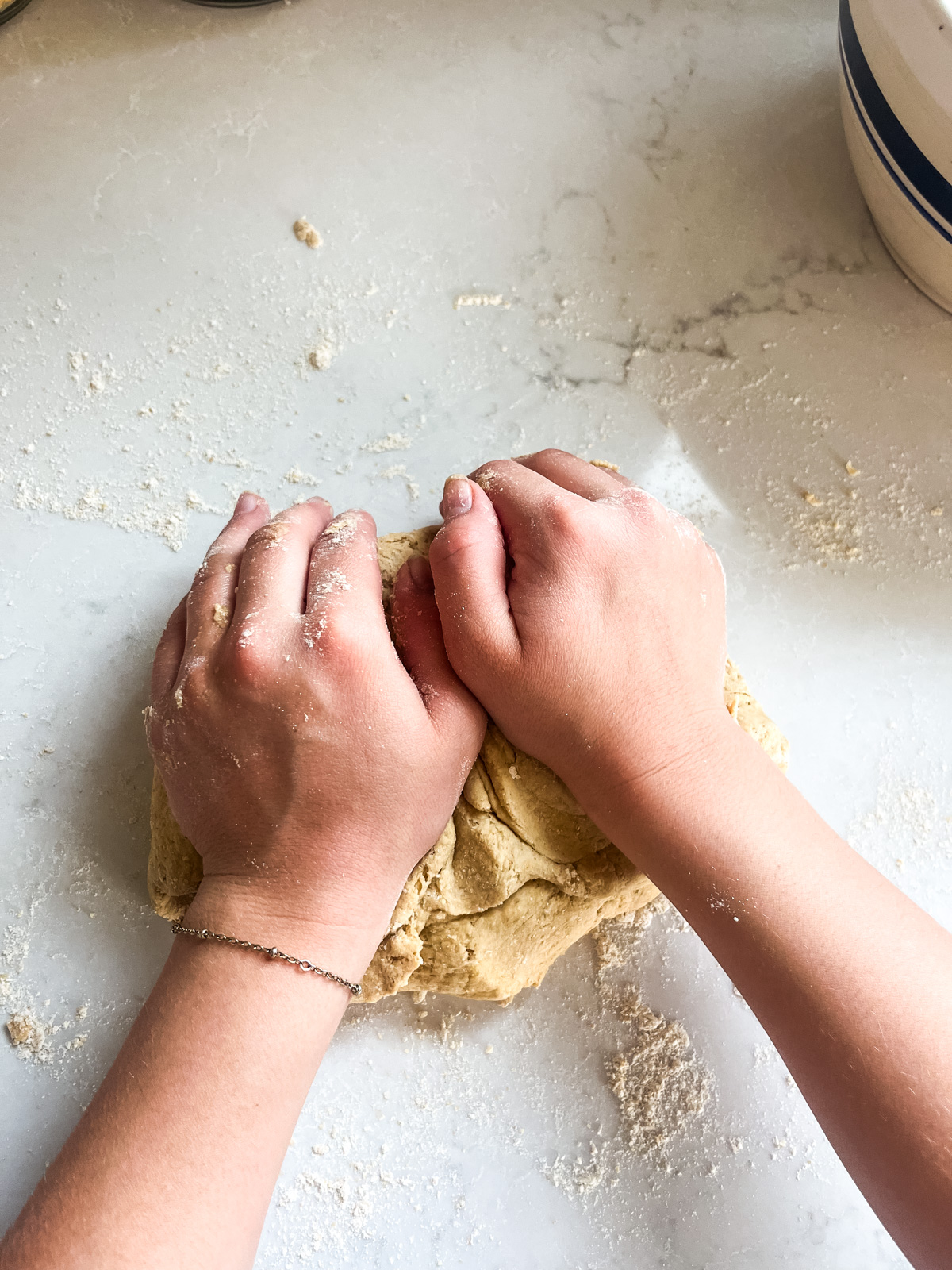 Kneading freshly milled tortilla dough.