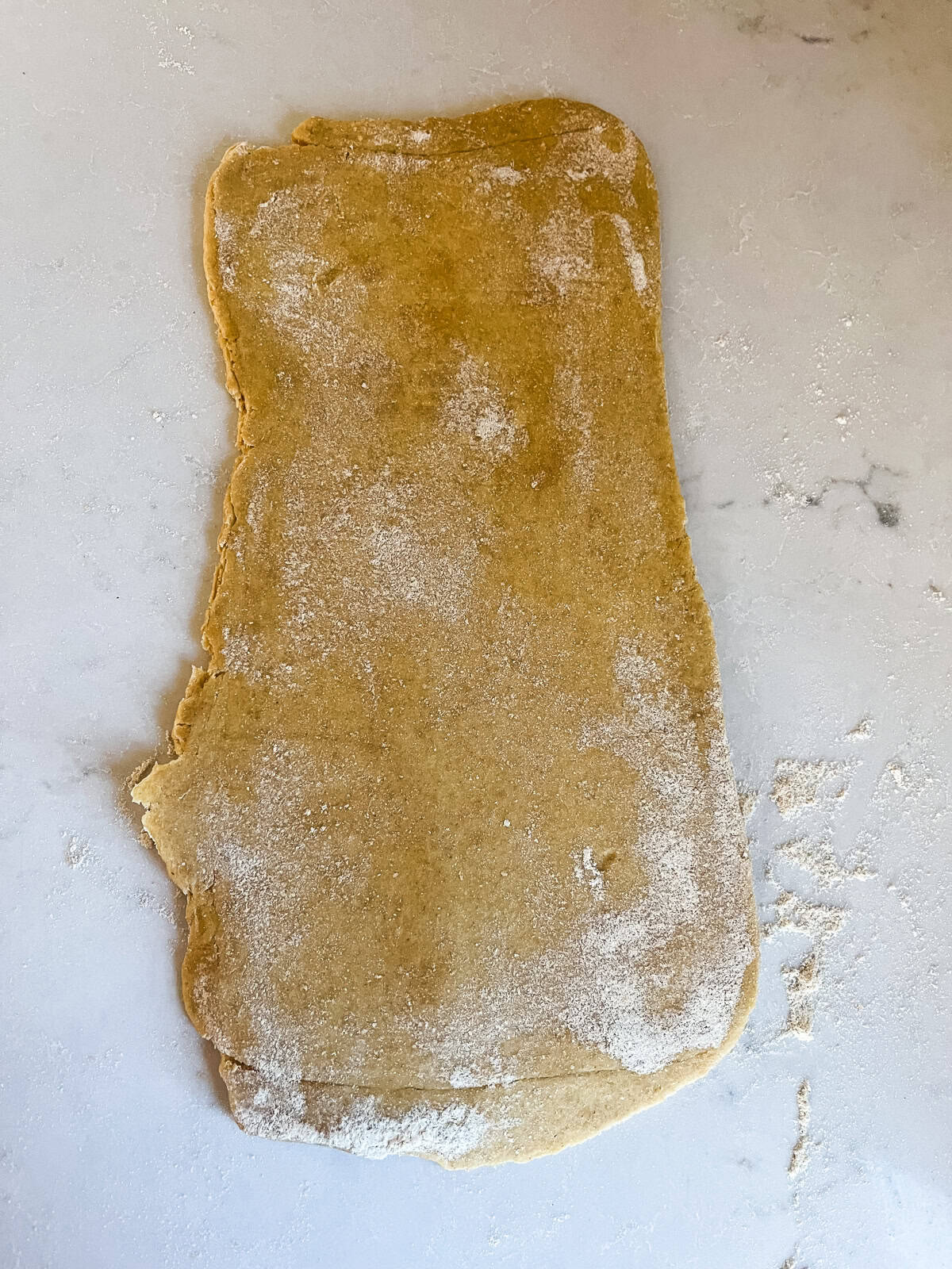 Donut dough flattened into a rectangle.
