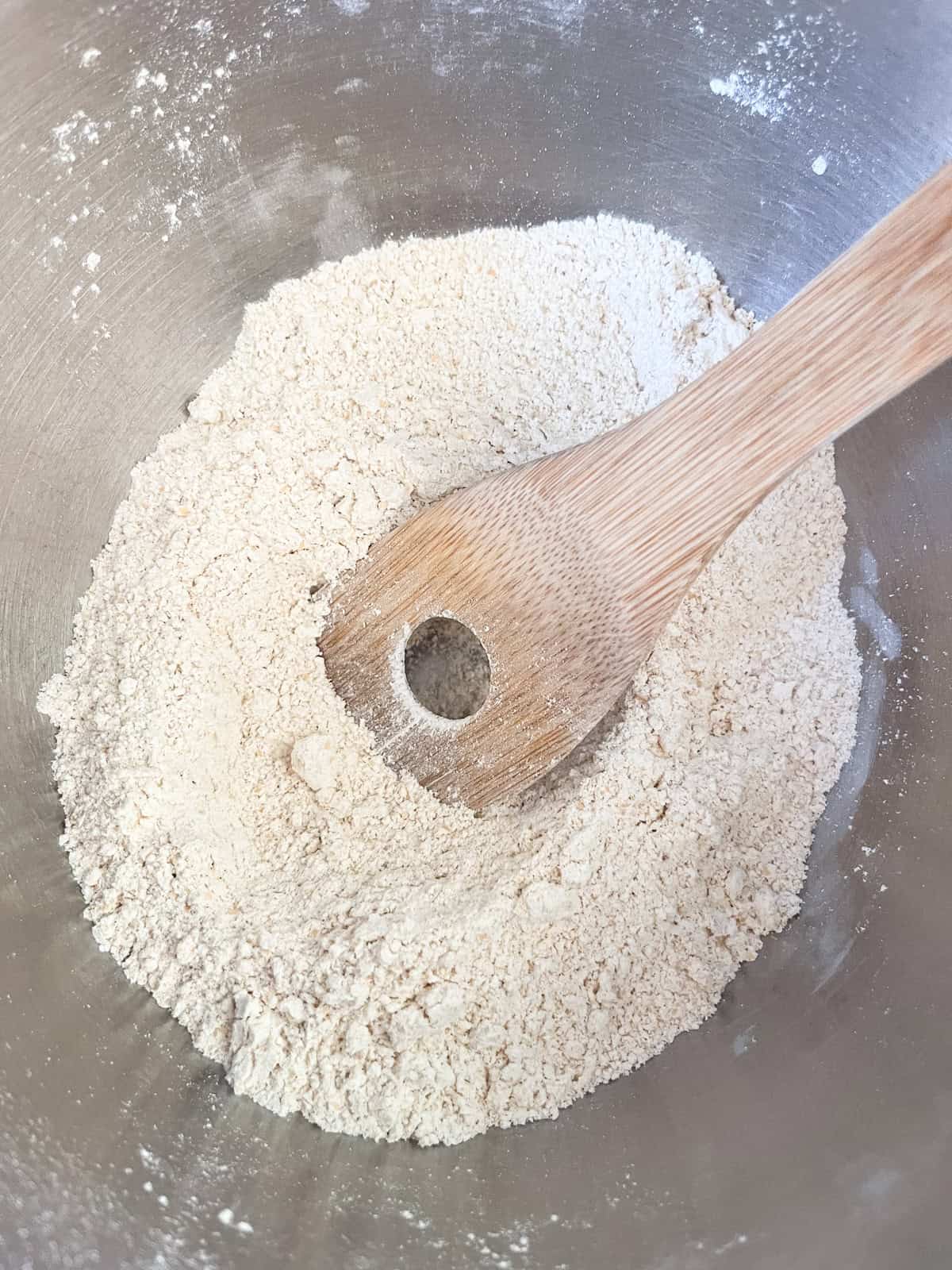 Stirring dry ingredients together in a bowl.